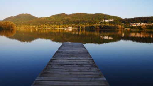 Pier over lake against sky