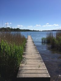 Pier over lake against sky