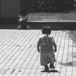 Full length of boy standing on slide