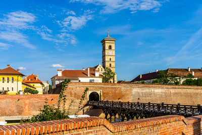 Buildings in city against sky