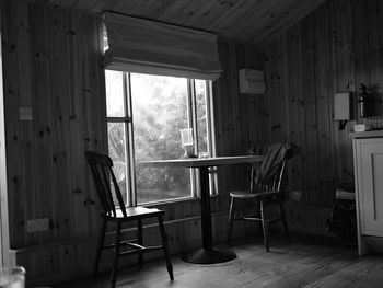 Empty chairs and table in building