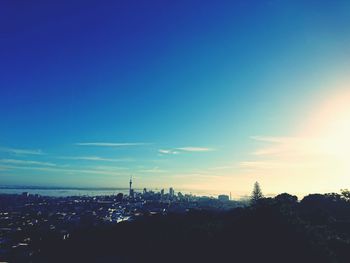 Silhouette cityscape against sky during sunset