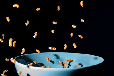 Close-up of water drops on glass against black background