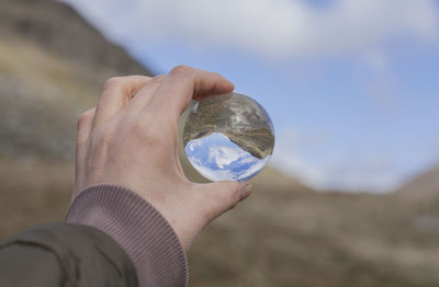 Close-up of hand holding crystal ball