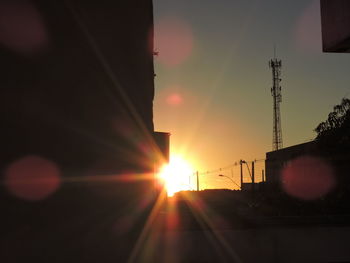 Silhouette buildings against sky during sunset