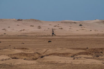 Scenic view of desert against clear sky