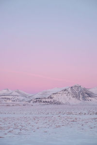 Scenic view of snowcapped mountains against sky during sunset