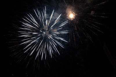 Low angle view of firework display at night