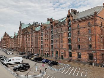 High angle view of street amidst buildings against sky