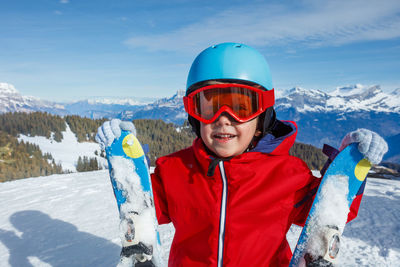 Portrait of smiling young man skiing on snow