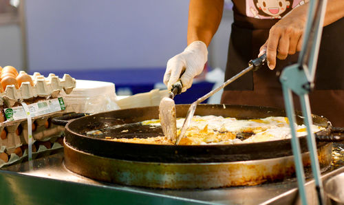 Midsection of man preparing food