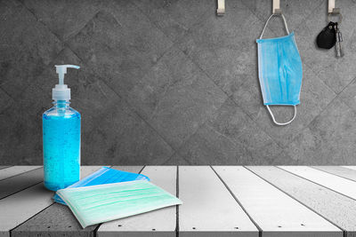High angle view of blue bottles on table against wall