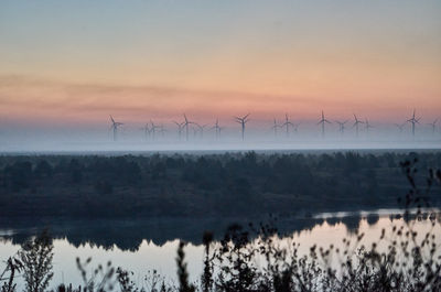 Scenic view of lake against sky during foggy weather