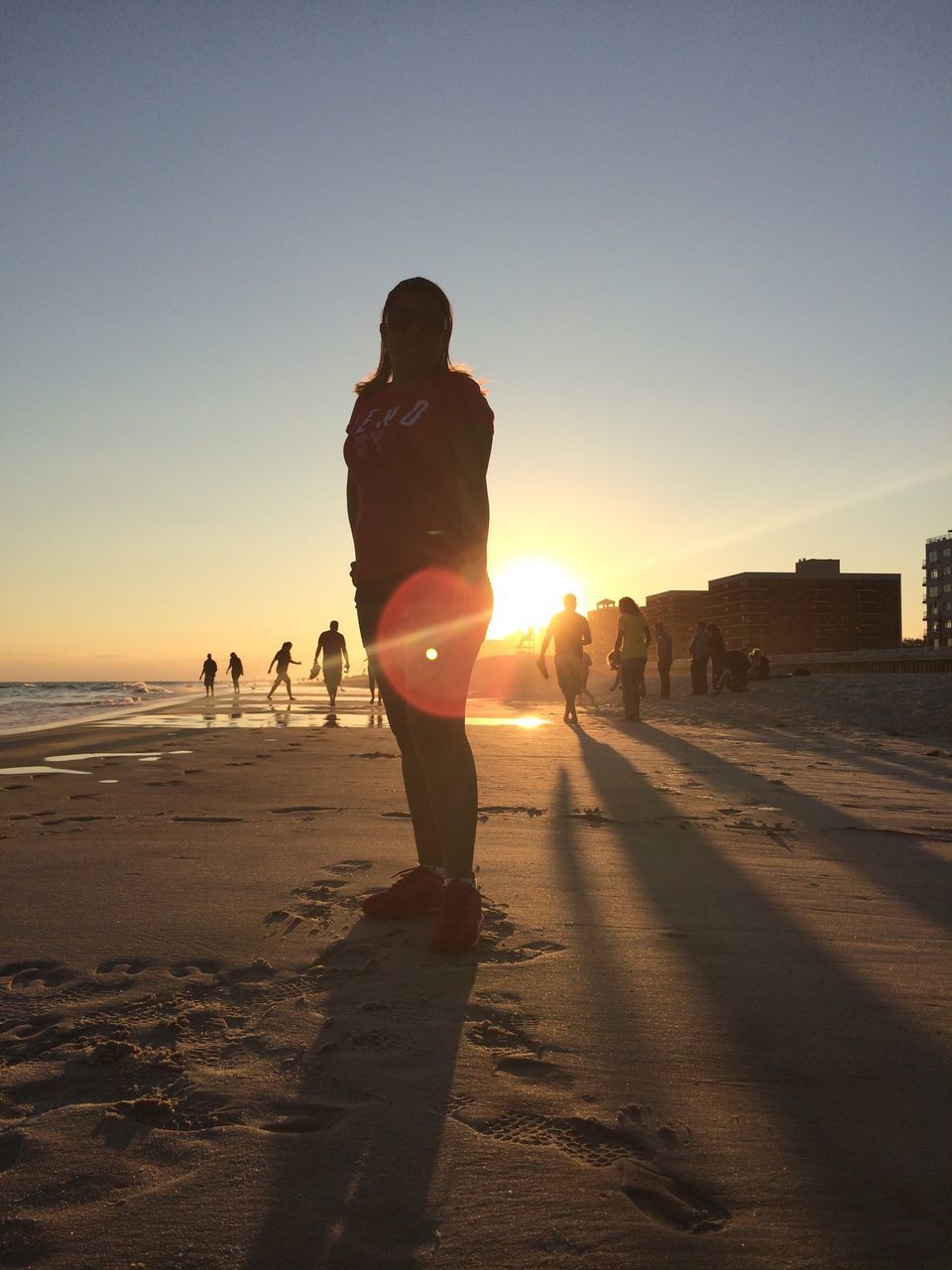 sunset, sun, beach, sea, lifestyles, leisure activity, sunlight, horizon over water, men, full length, shore, silhouette, lens flare, clear sky, sky, sunbeam, sand, person, water