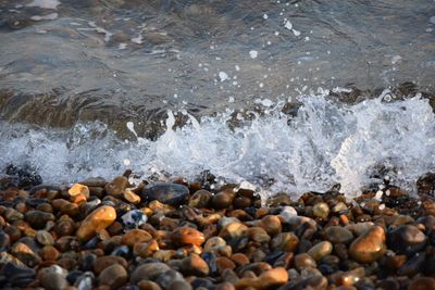 Close-up of pebbles in sea