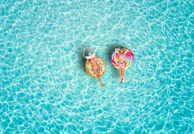 High angle view of people on inflatable ring in pool