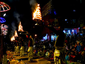 Crowd at illuminated city at night