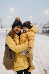 Happy woman standing in snow