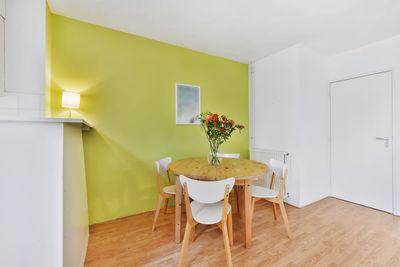 Table and chairs on floor against wall at home