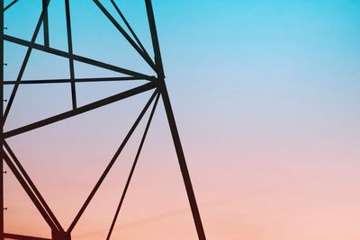 Low angle view of silhouette metallic structure against sky during sunset