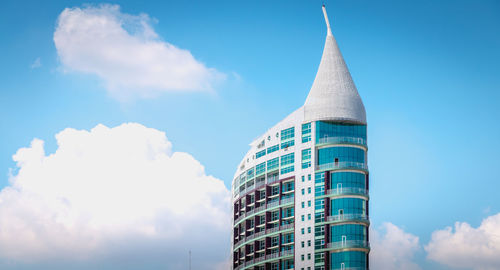 Low angle view of buildings against cloudy sky