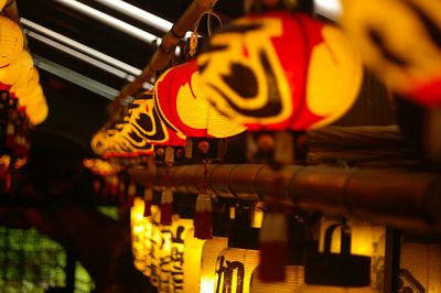 Illuminated chinese lanterns hanging indoors at night