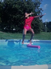 Full length of boy jumping in swimming pool