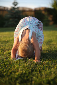 Young girl playing on grass