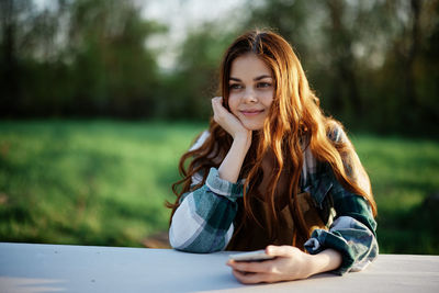 Young woman sitting on field