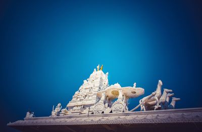 Low angle view of statue against clear blue sky