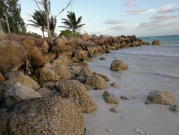 Rocks on beach against sky