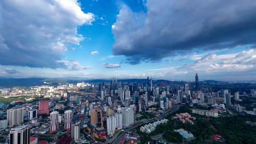 High angle view of modern buildings in city against sky