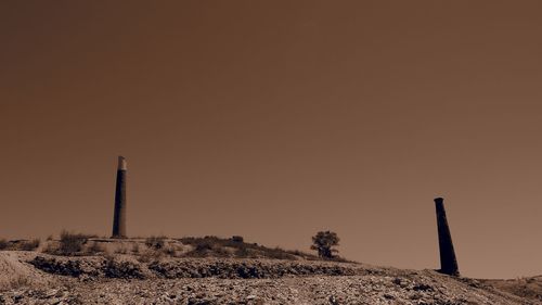 Built structure on landscape against clear sky