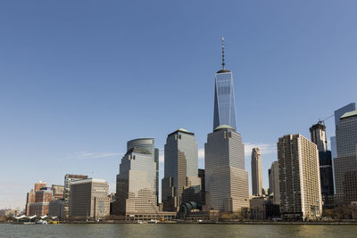 Modern buildings in city against clear sky