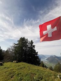 Red flag on landscape against sky