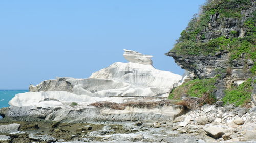 Low angle view of rock formations against sky