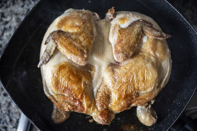 High angle view of meat chicken in cooking pan