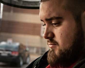 Close-up portrait of young man looking away
