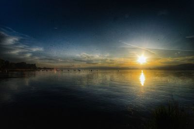 Scenic view of lake against sky during sunset