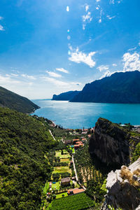 High angle view of sea and mountains against sky