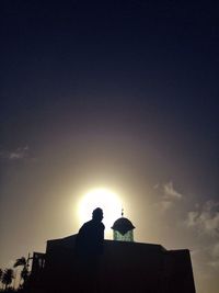 Low angle view of silhouette built structure against sky