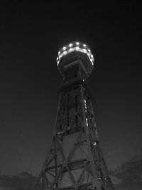 Low angle view of communications tower against sky
