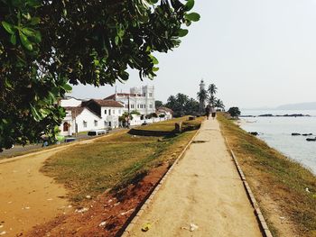 Town by sea against clear sky