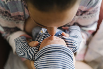 Mother rubbing nose with baby boy