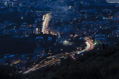 High angle view of city lit up at night