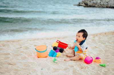Boy playing with toy on beach