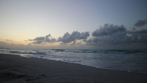 Scenic view of beach against sky during sunset