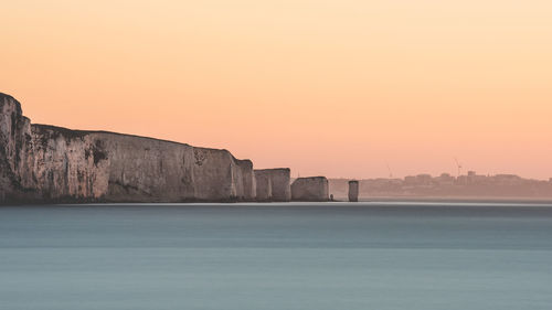 Scenic view of sea against clear sky during sunset