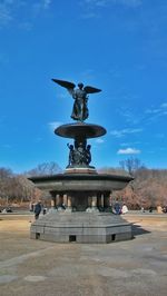 Low angle view of statue against blue sky