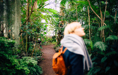 Side view of woman walking in forest